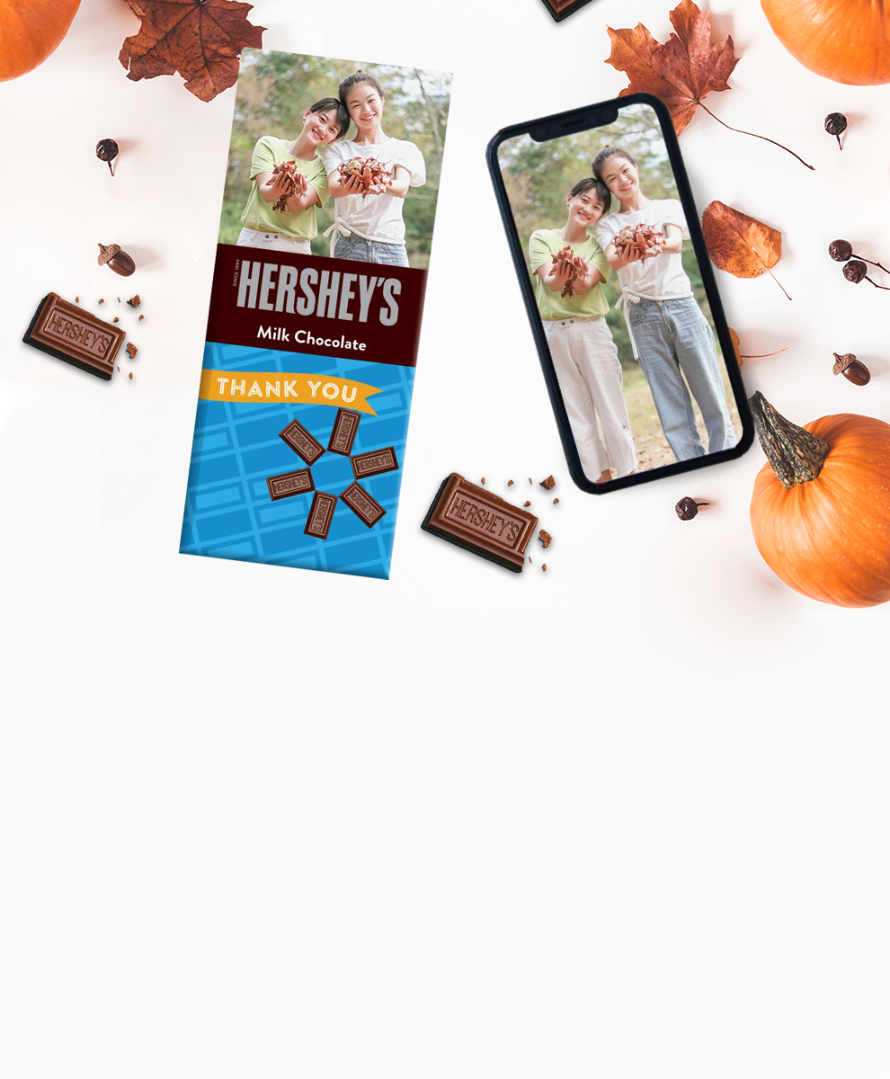 HERSHEY'S Bar with fall-themed personalized wrapper and iPhone on white background