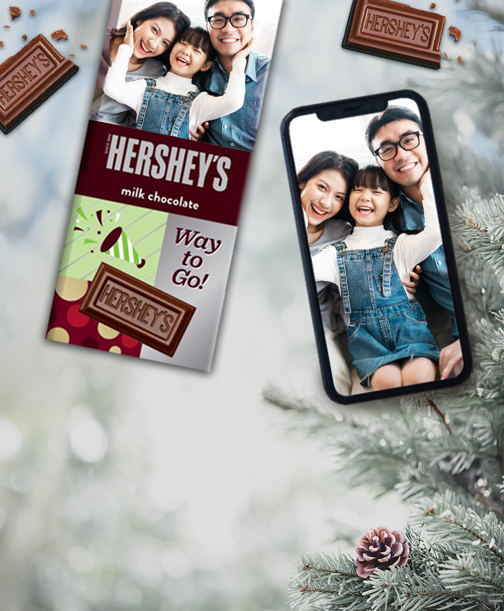 HERSHEY'S Bar with cold weather-themed wrapper next to an iPhone
