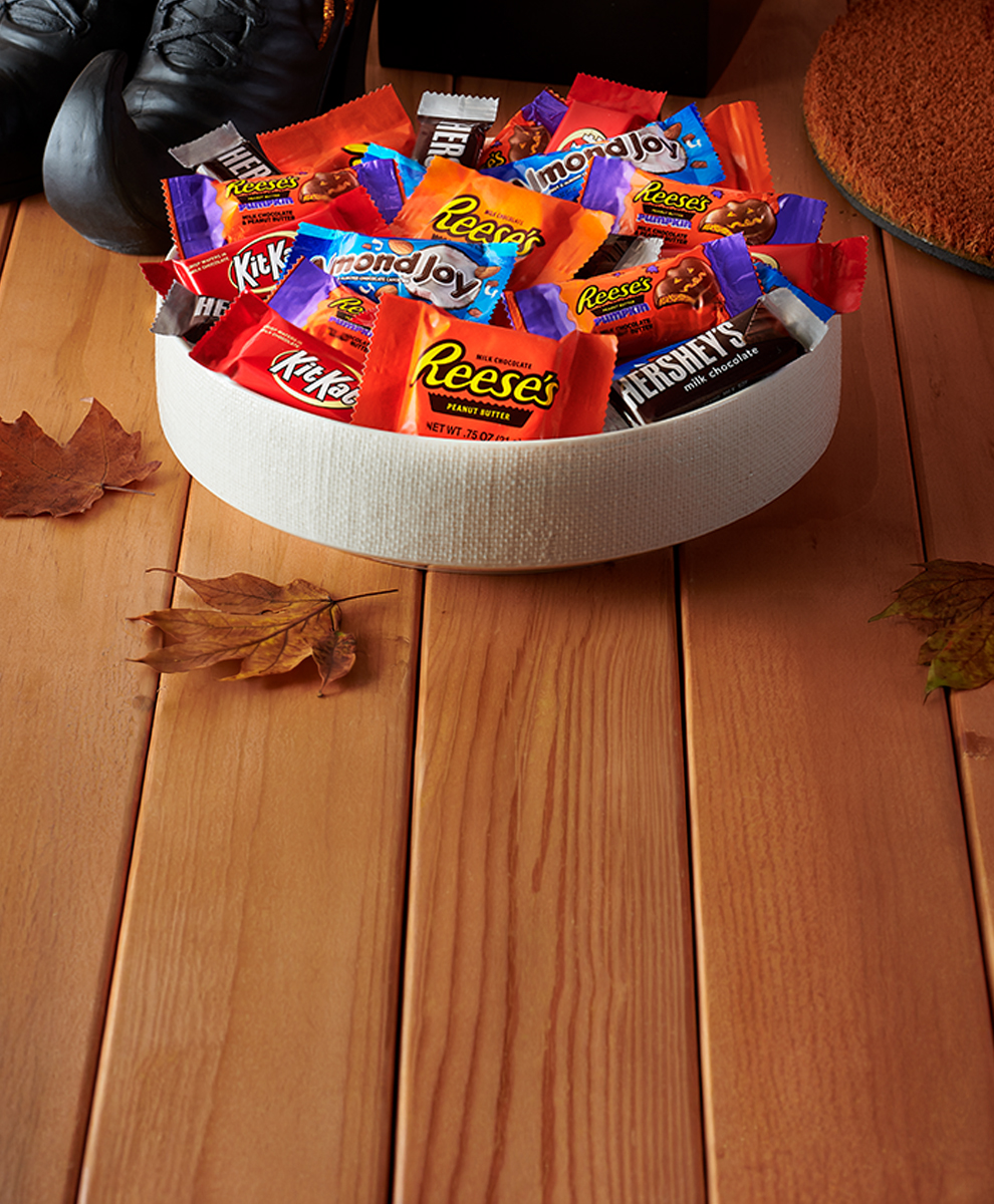 Promotional graphic featuring Halloween candies with a monster packaging