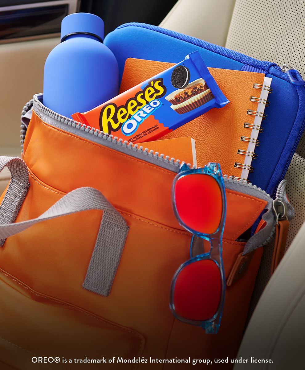 Promotional graphic featuring a pack of REESE'S OREO® Peanut Butter Cups in a bag sitting in the front seat of a car