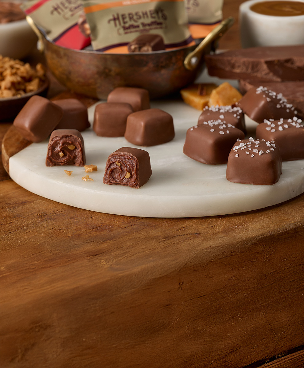 Promotional graphic featuring HERSHEY'S Toffee Truffles on a marble serving tray