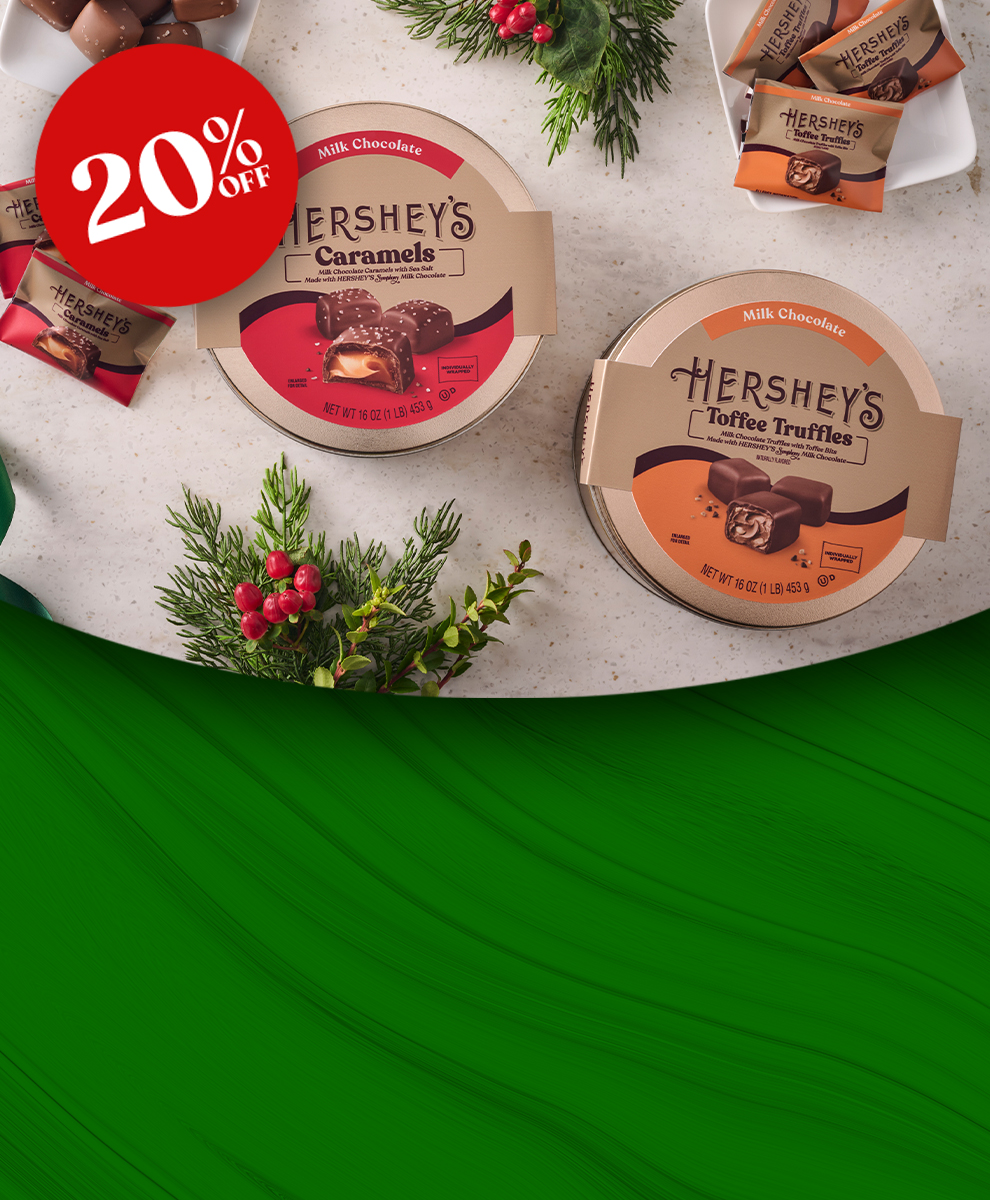 Promotional graphic featuring HERSHEY'S Caramels and Toffee Truffles gift tins on a marble countertop