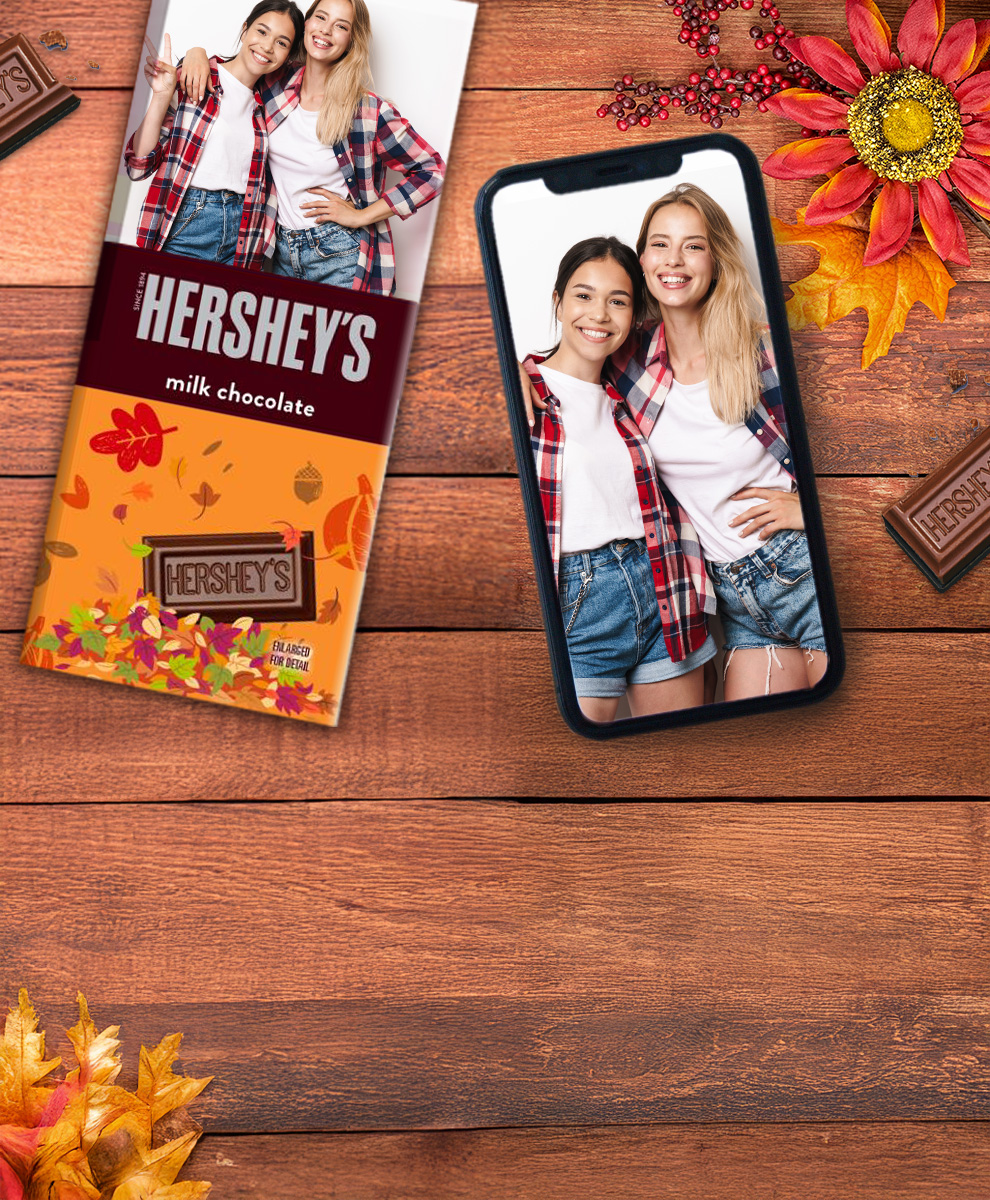 HERSHEY'S Bar with personalized fall-themed wrapper next to an iPhone