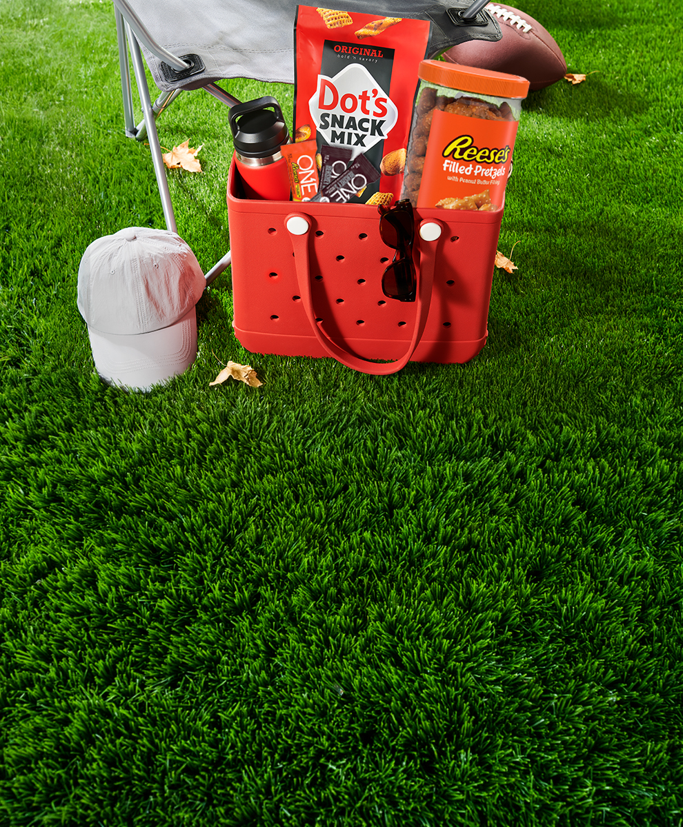 promotional graphic featuring summer snacks including DOTS snack mix and Reese's peanut butter pretzels while outside