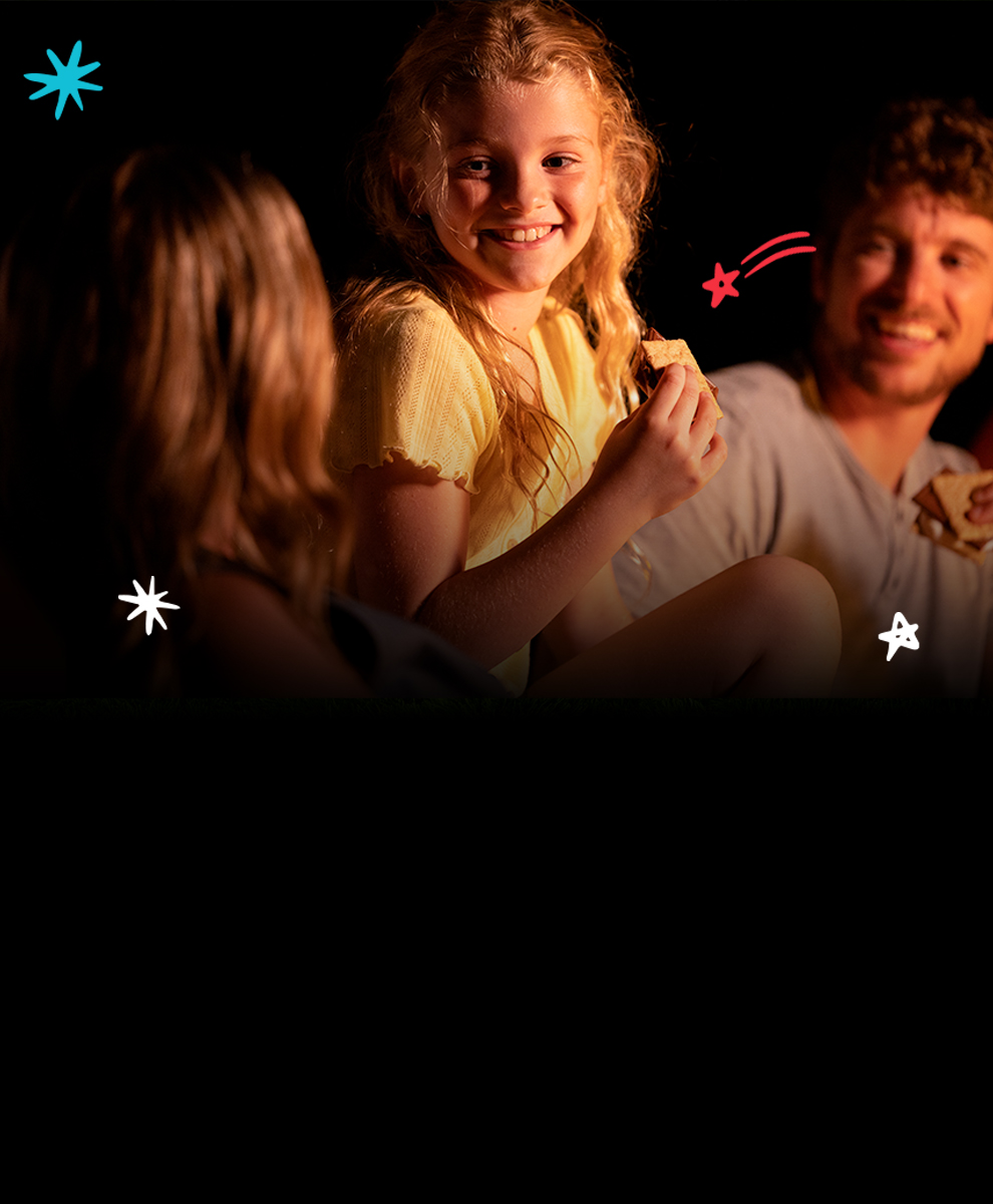 Promotional graphic featuring s'mores supplies of variety of Hershey's milk chocolate bars at a campsite
