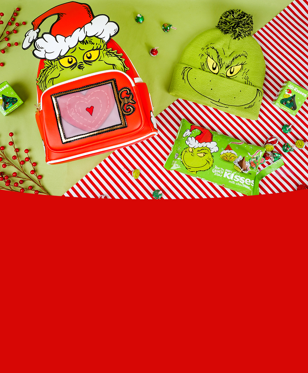 Grinch merchandise collection and Grinch KISSES Chocolate on green tabletop 