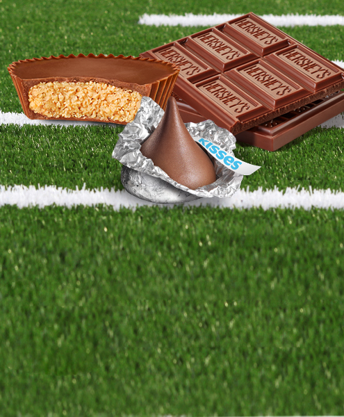 REESE's, KISSES, and HERSHEY's chocolate candies on football field turf