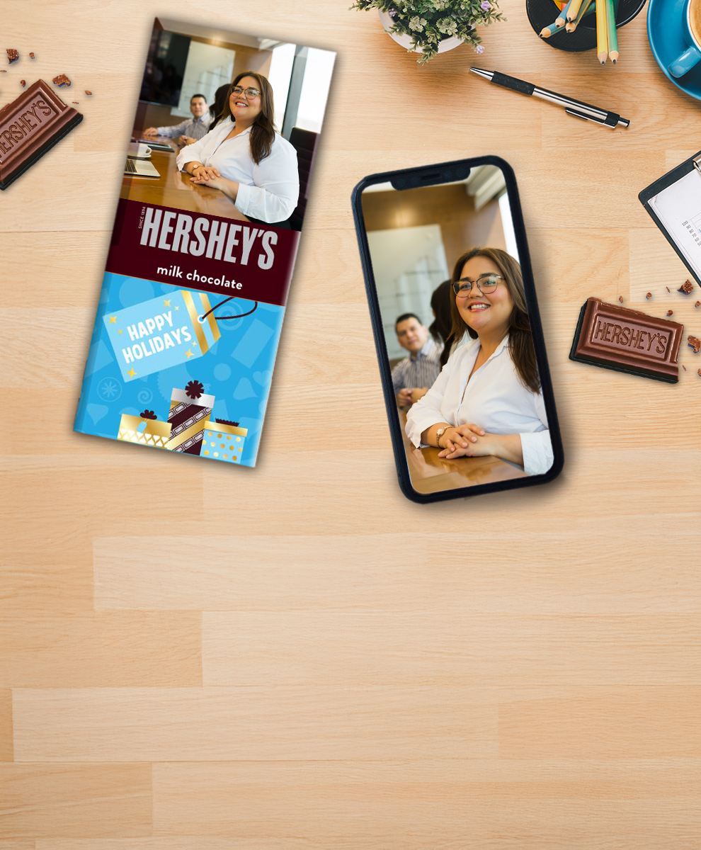 HERSHEY'S Bar with personalized Fall-themed wrapper next to an iPhone