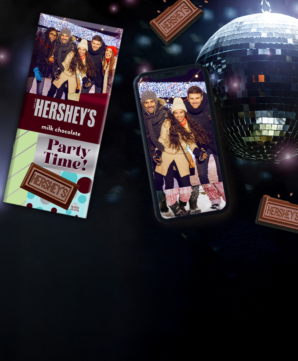 HERSHEY'S Bar with personalized holiday-themed wrapper next to an iPhone