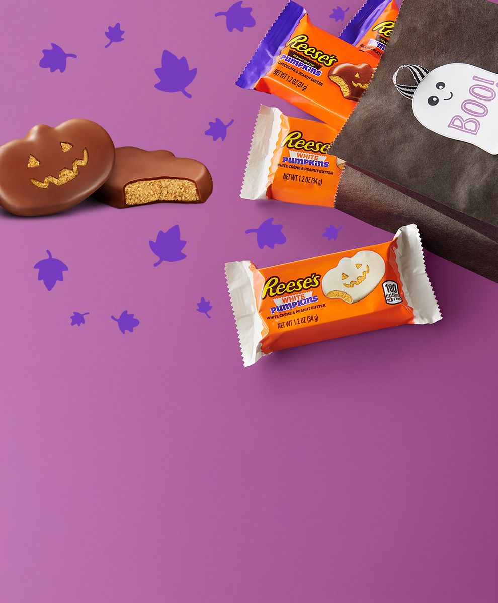 Wrapped and unwrapped REESE'S Milk and White Chocolate and Peanut Butter Pumpkins spilling out of a bag