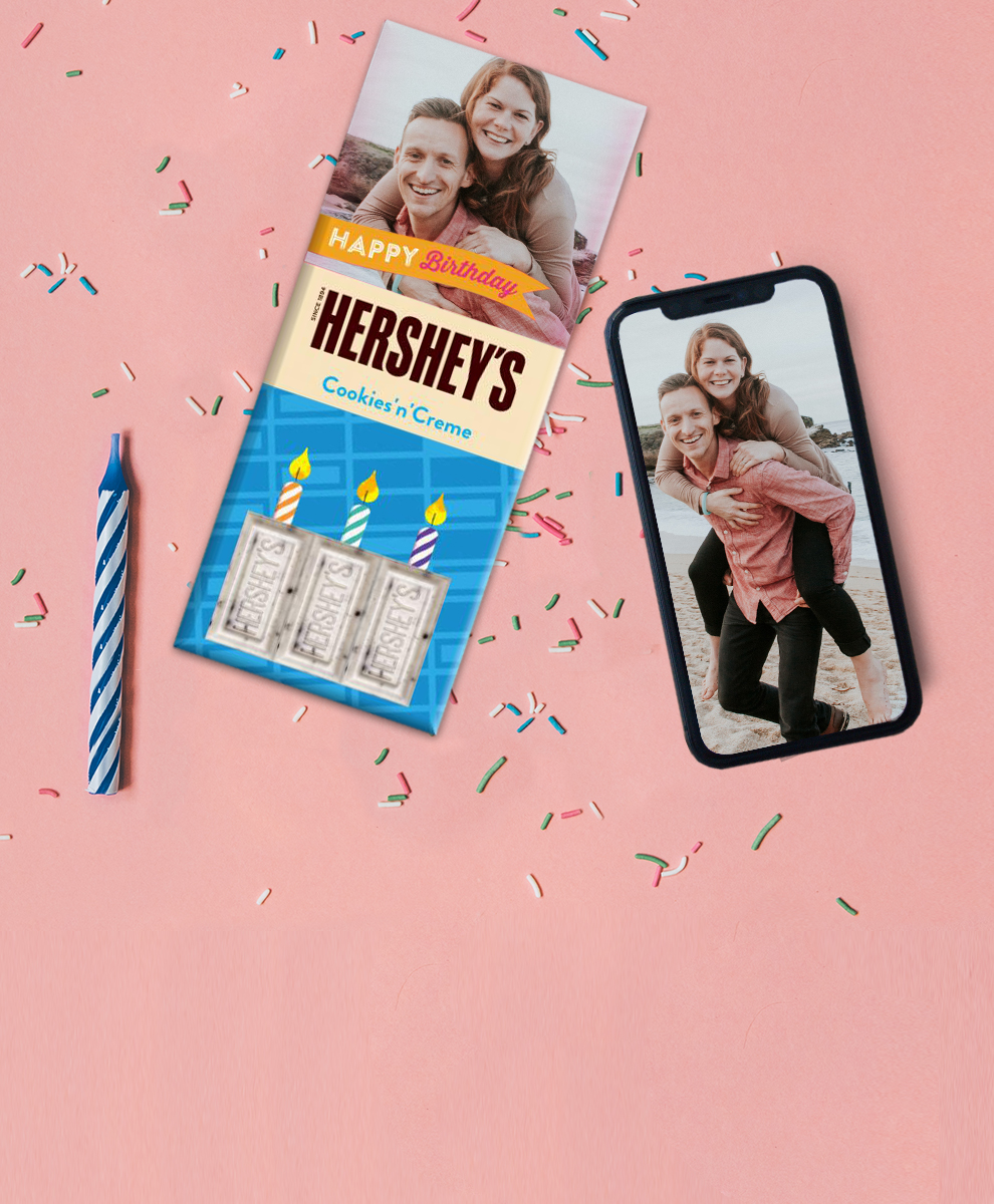 Personalized HERSHEY'S Cookies' n' Creme Bar next to smartphone