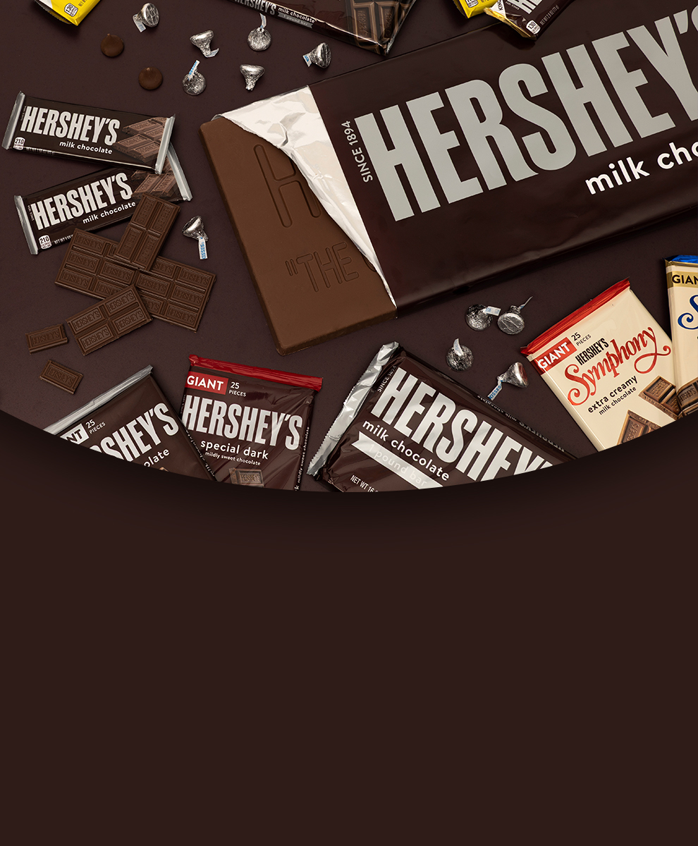 Promotional graphic featuring assortment of wrapped and partially unwrapped chocolate bars and pips on a brown background