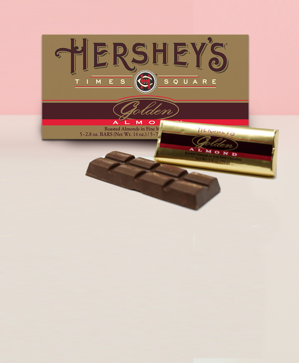 Wrapped and unwrapped HERSHEY'S Golden Almond Bars on white tabletop