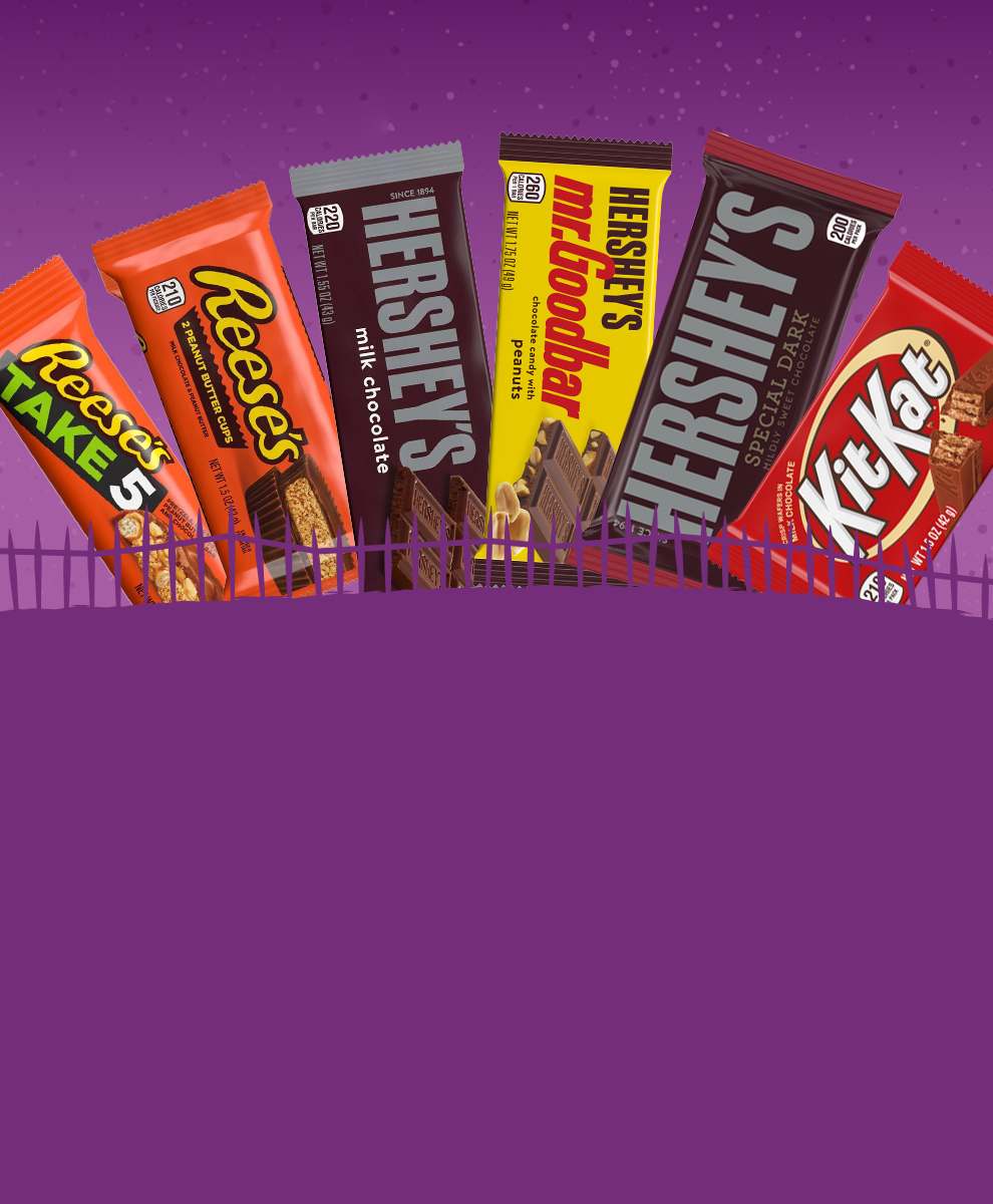 Assortment of full size Hershey Candy bars on a purple Halloween background