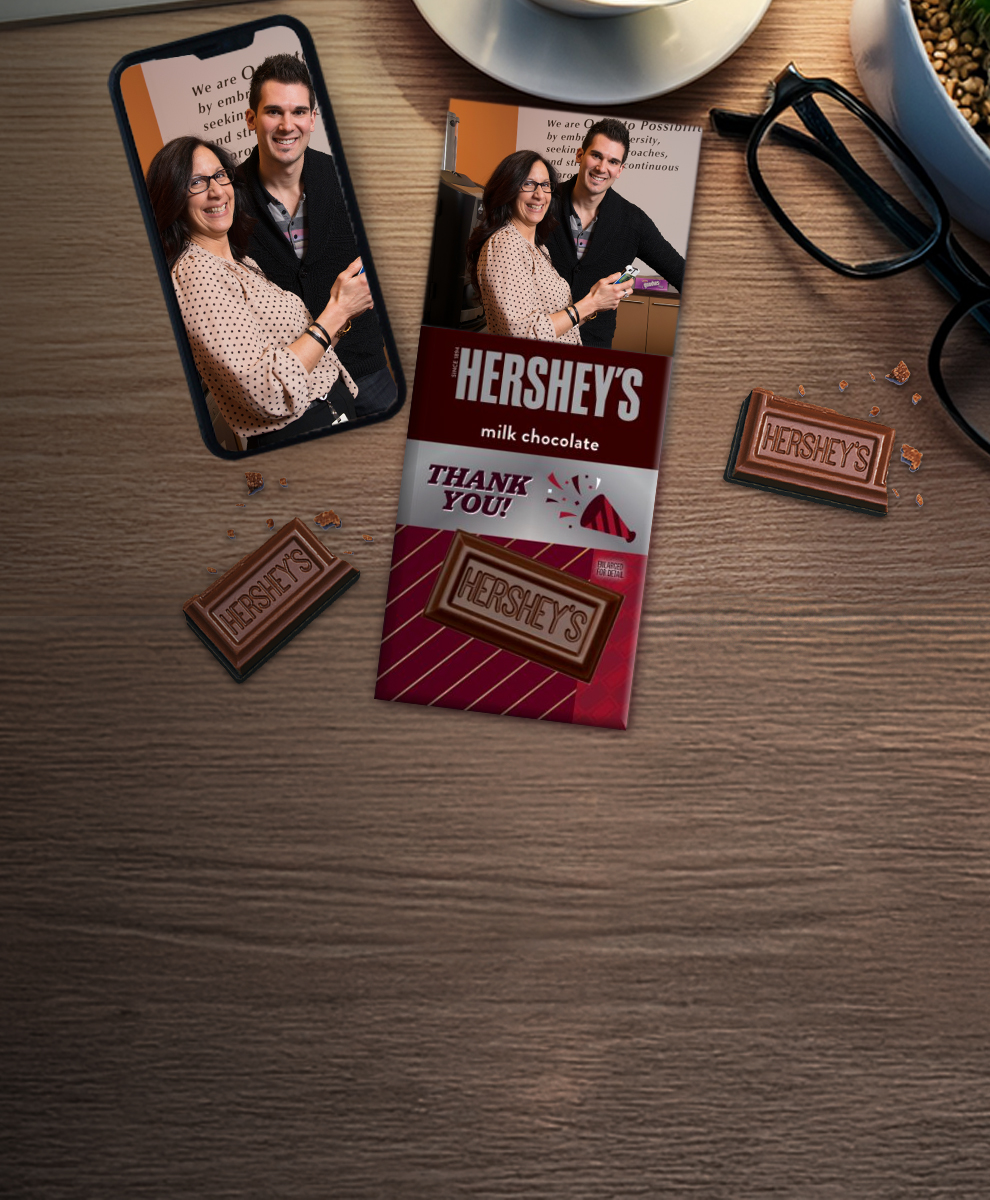 HERSHEY'S Bar with office-themed wrapper next to an iPhone