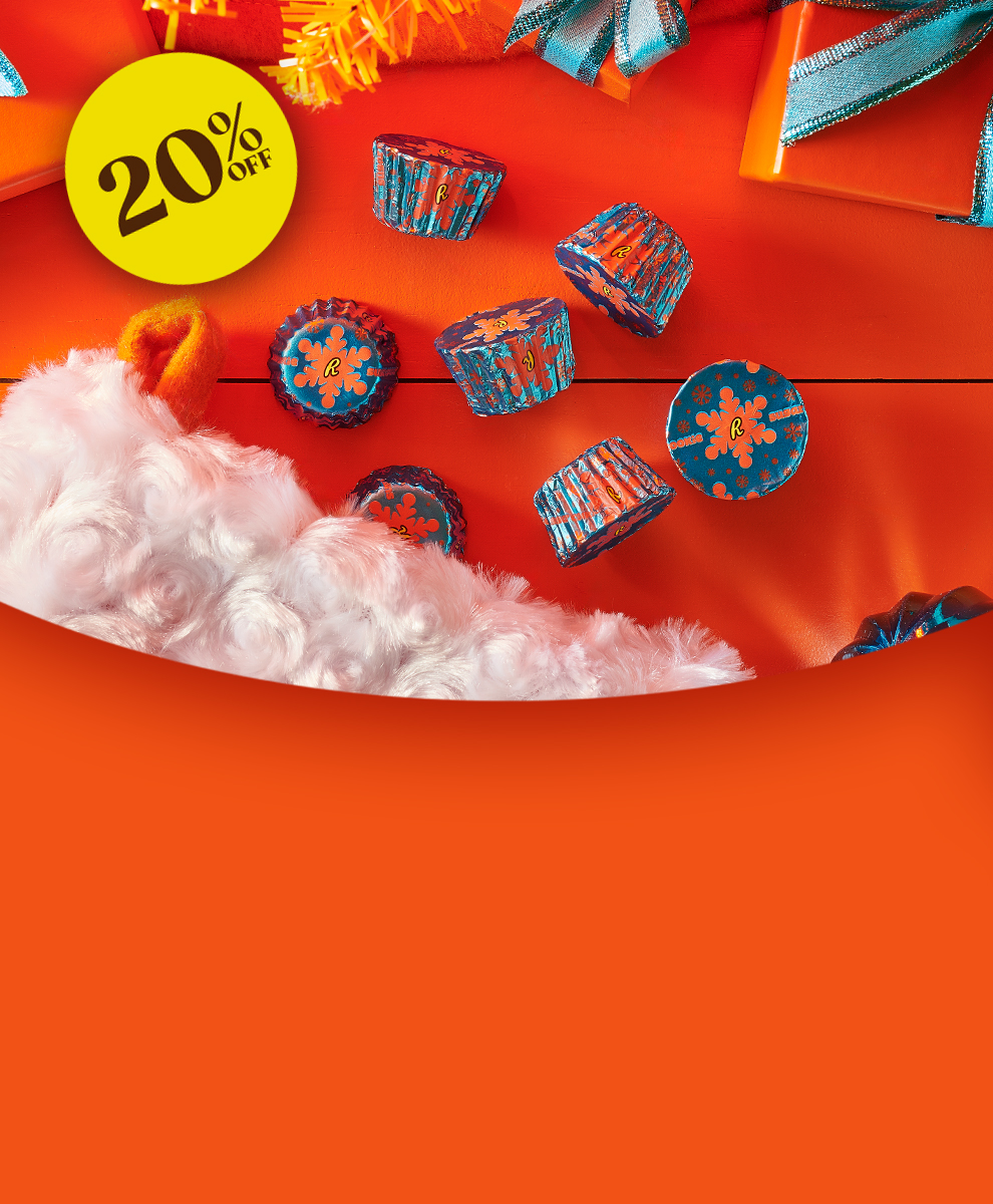 Promotional graphic featuring REESE'S Sugar Cookie Miniature Peanut Butter Cups on an orange tabletop