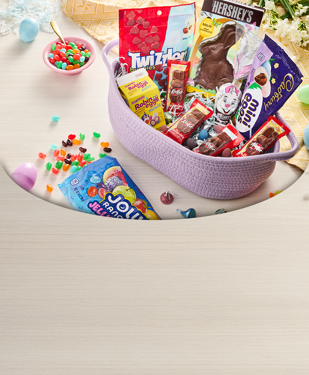 Promotional graphic featuring a variety of easter candies and chocolates in an Easter basket