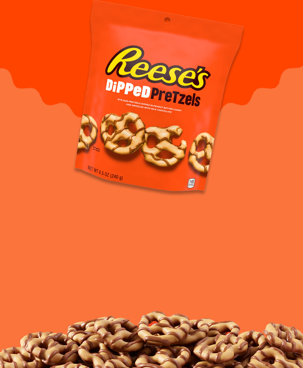 Package of REESE'S Dipped Pretzels overlaid on piled Dipped Pretzels