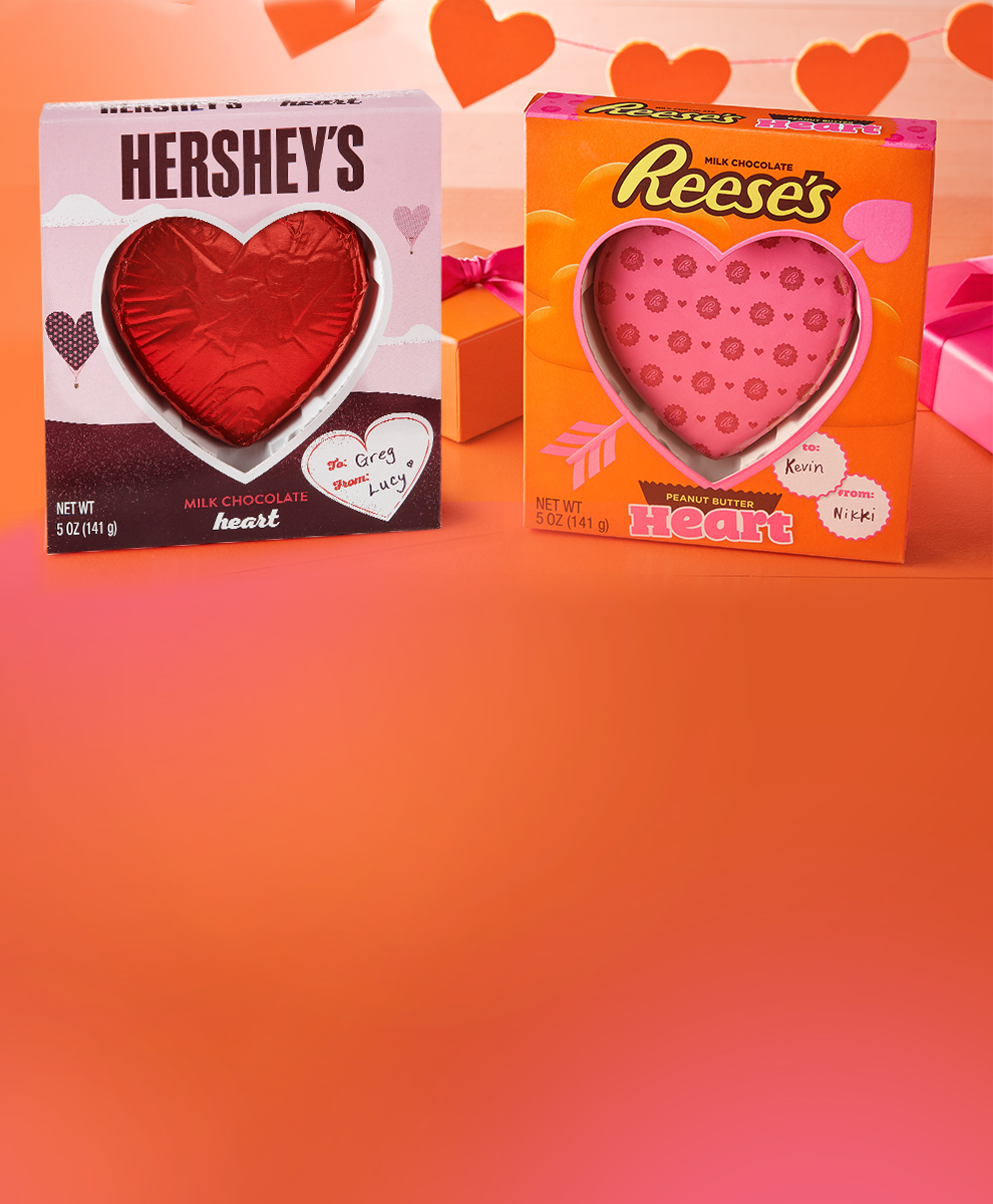 Packaged HERSHEY'S & REESE'S Chocolate Hearts on orange/pink background