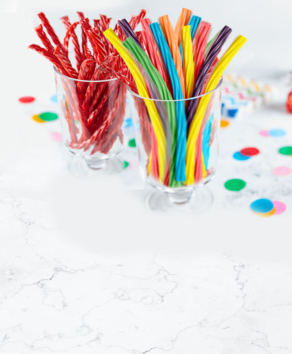 TWIZZLERS Twists arranged in glasses on decorated tabletop