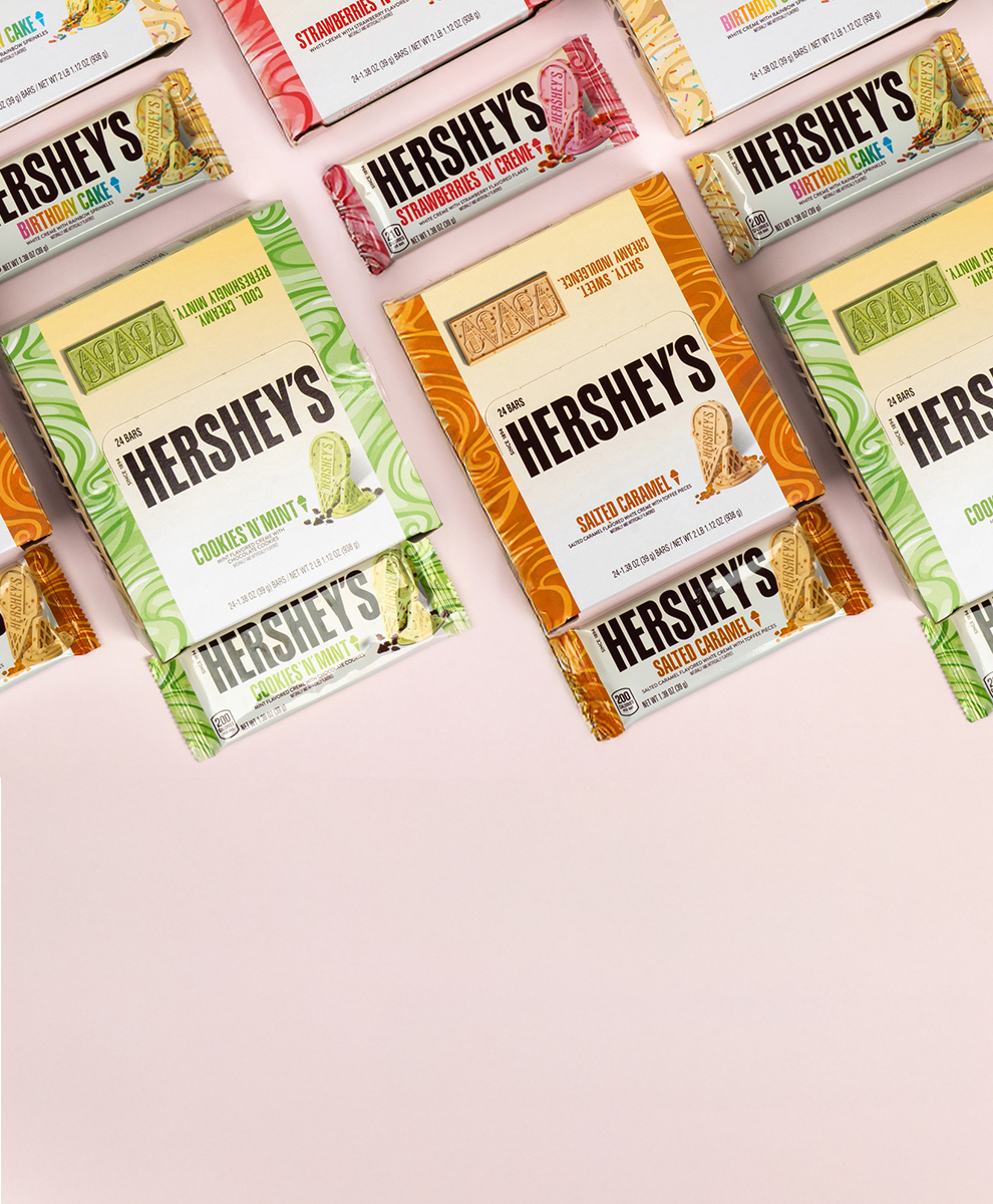Promotional graphic featuring HERSHEY'S Ice Cream Flavored chocolate bar boxes in assorted flavors