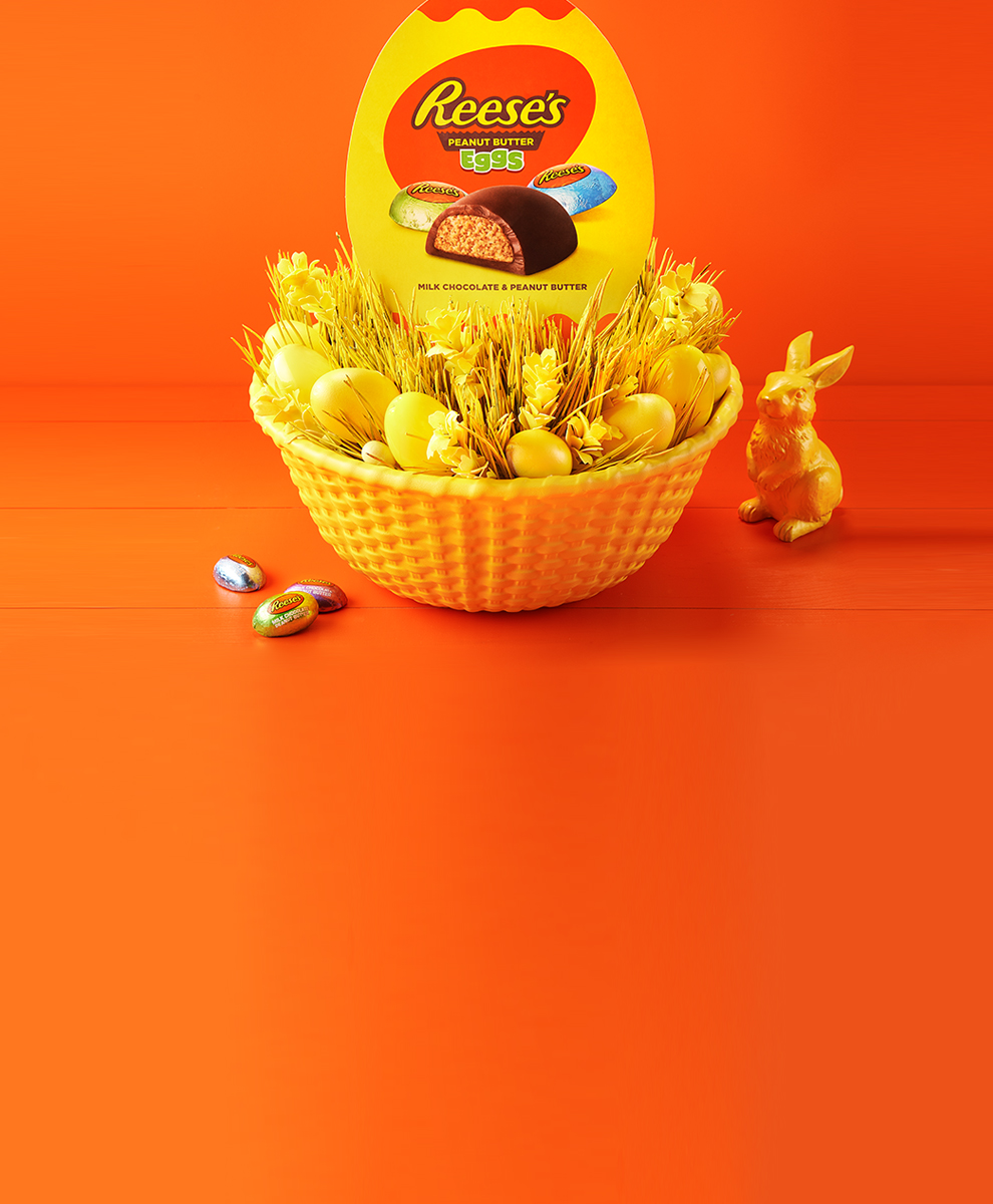 REESE'S Peanut Butter Eggs in yellow Easter basket on orange background