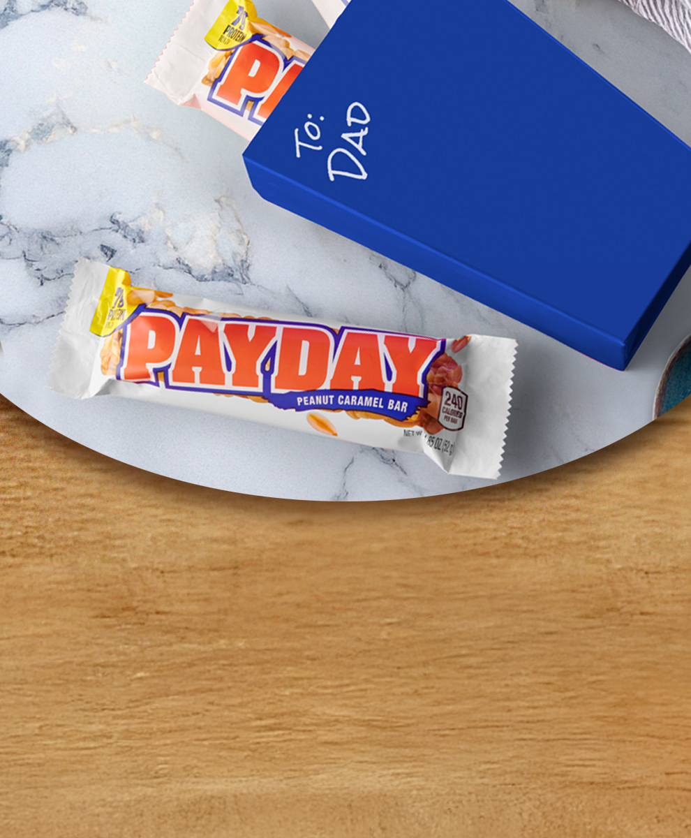 Promotional graphic featuring Payday Caramel Bar on marble table for father's day gift