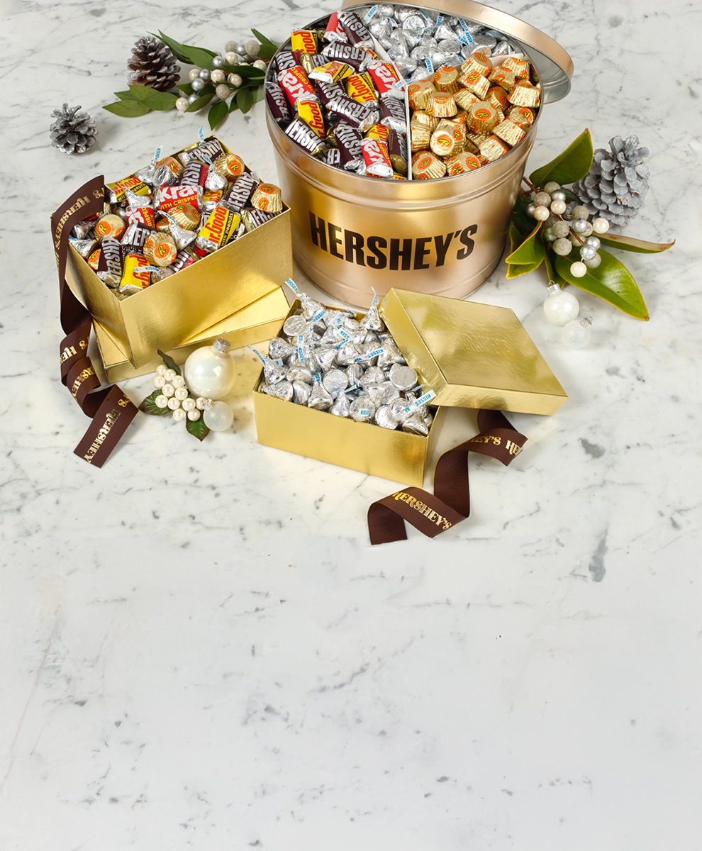 HERSHEY'S holiday gift basket spilling onto a green background