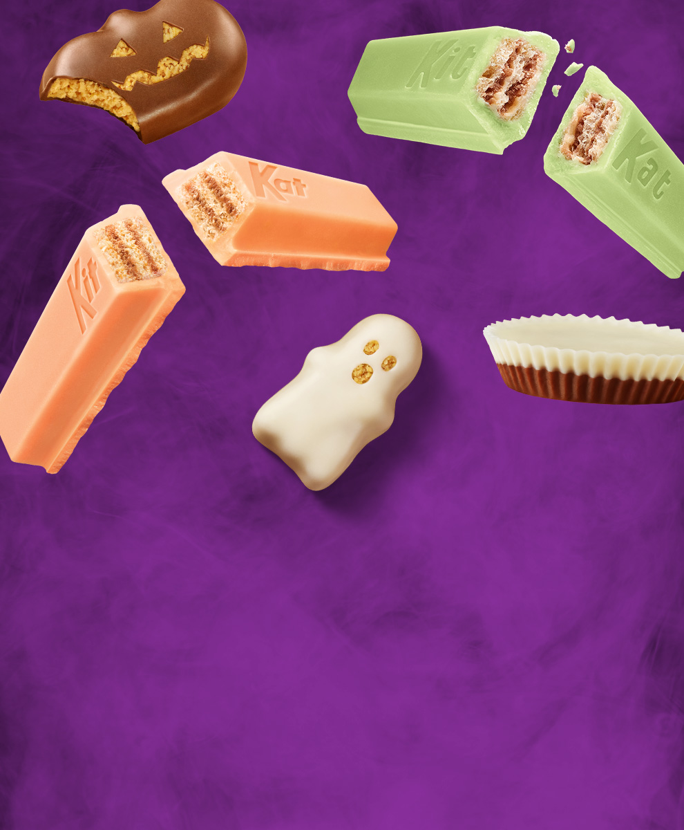 Assorted Halloween candies on a purple background
