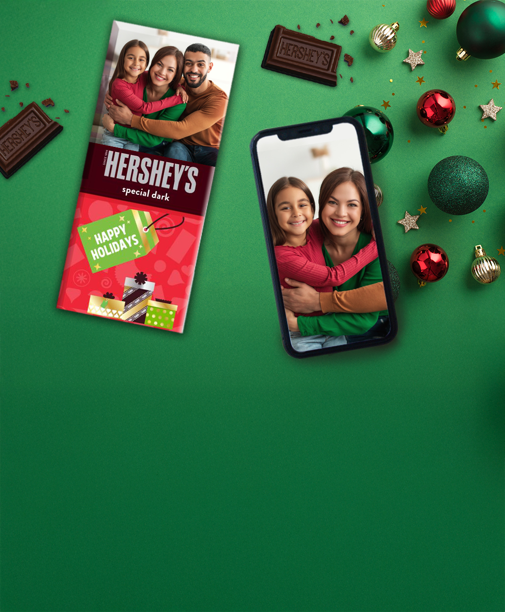 HERSHEY'S Bar with personalized Christmas-themed wrapper next to an iPhone