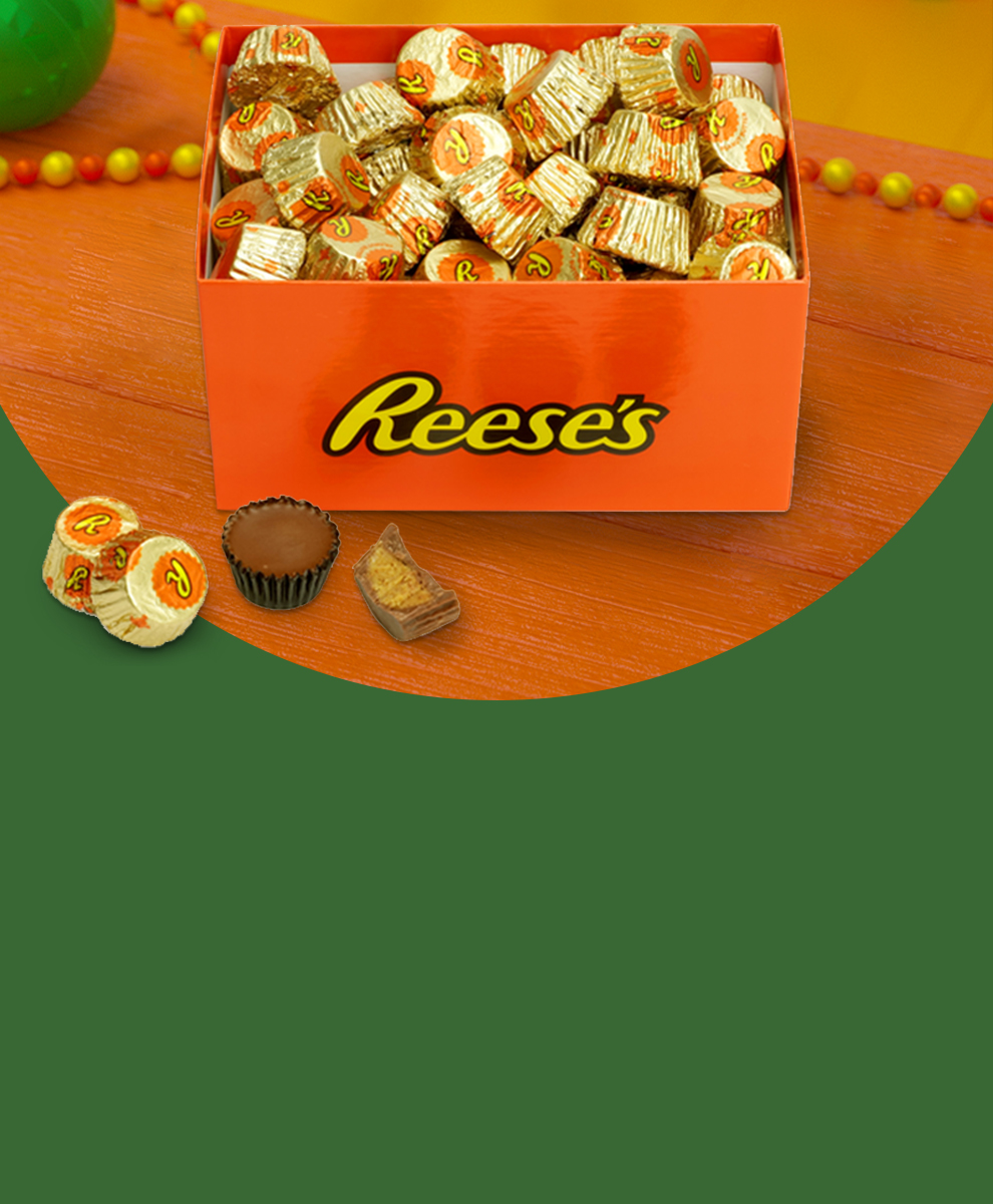 REESE'S Branded Gift Box displayed open on a tabletop with garland and gifts