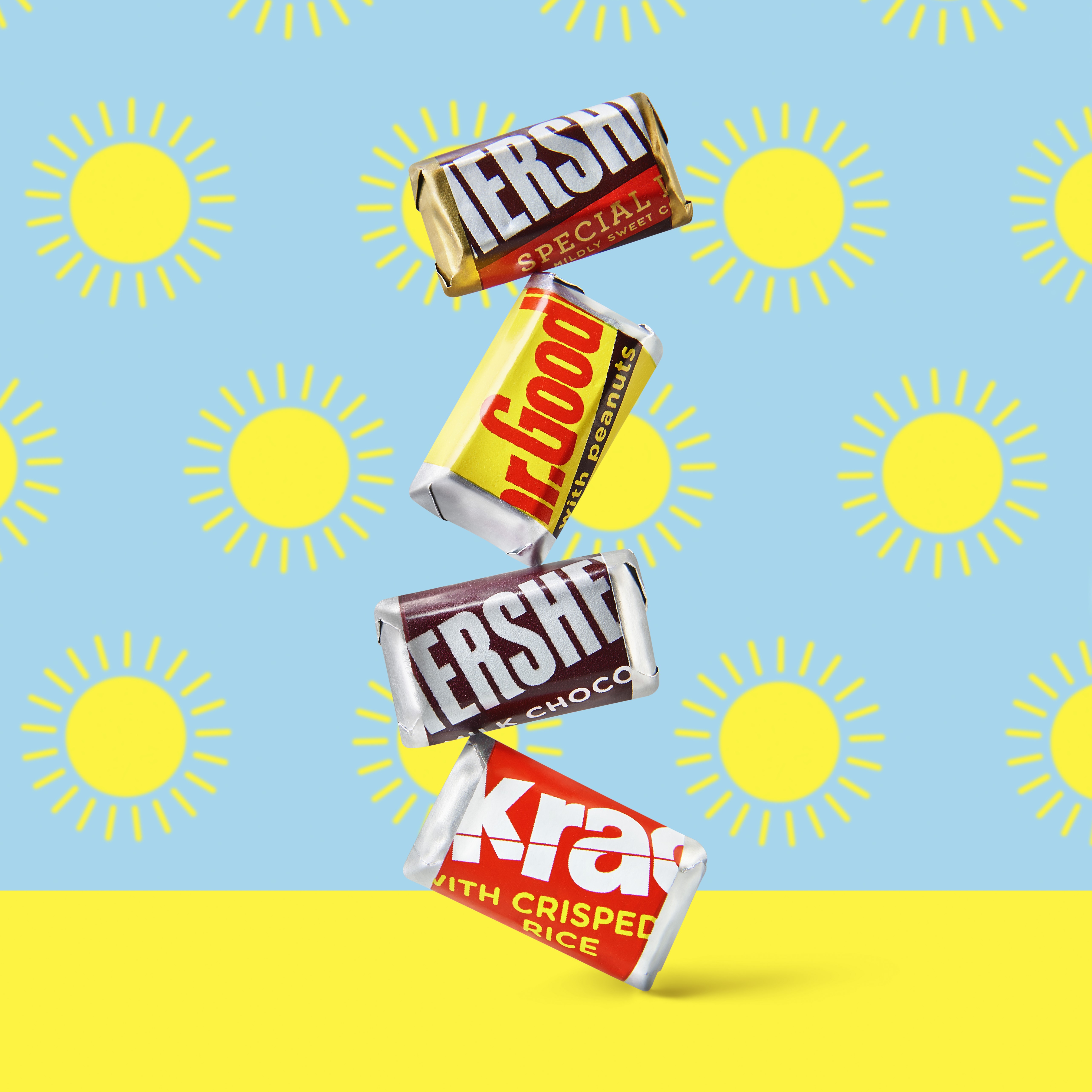 Assorted HERSHEY'S candies on Blue and Yellow Background with a sun pattern