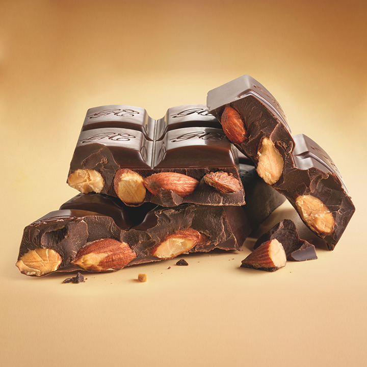 HERSHEY'S Golden Almond Chocolate Bar broken apart to reveal crisp almonds