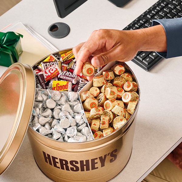 HERSHEY'S assorted 11-lb gift tin on a top of a desk
