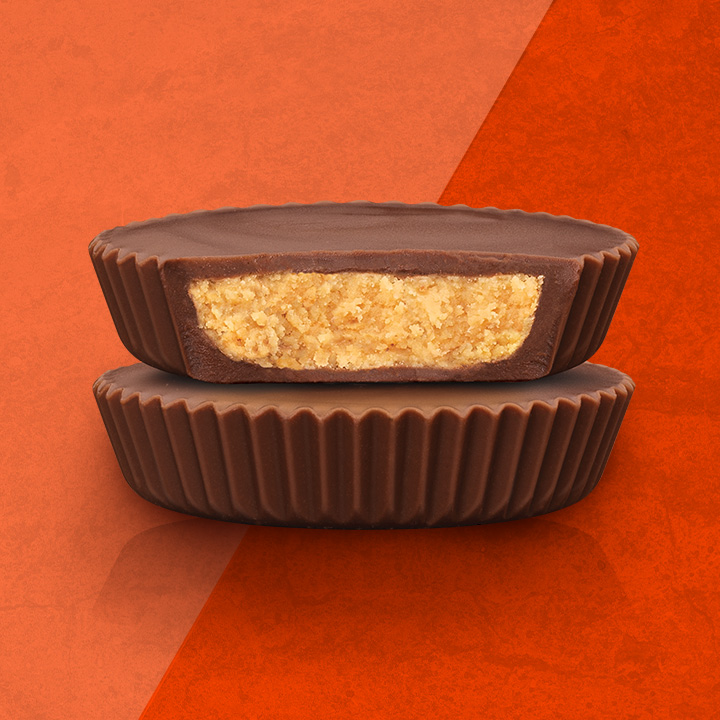 Two Organic REESE'S Cups stacked on orange two-tone background