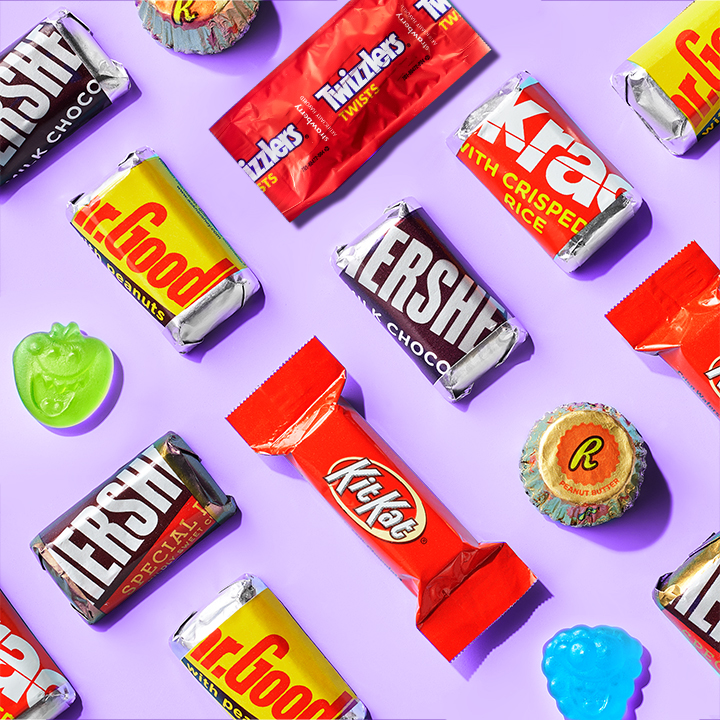 HERSHEY'S assorted miniature candy bars and HERSHEY'S Kisses on a purple background