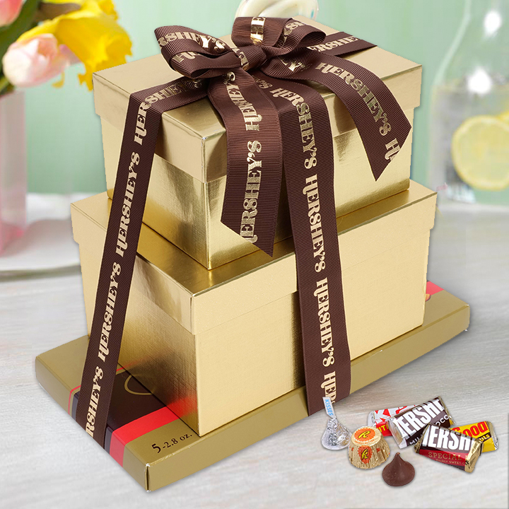 Gold-wrapped chocolate gifts from Hershey on a spring-themed tabletop