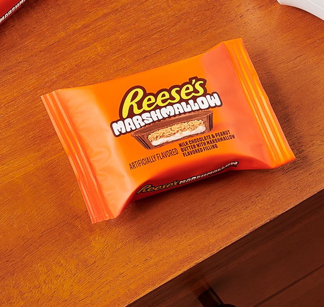Promotional graphic showing a REESE's Peanut Butter Cup with Marshmallow Flavored Filling