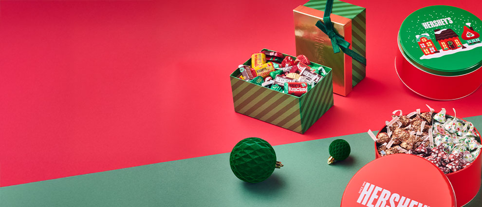 Candy Cane toys filled with Hershey's candy on a red and green background