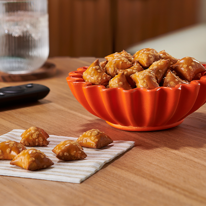 Promotional graphic featuring a bowl filled with REESE'S Filled Pretzels