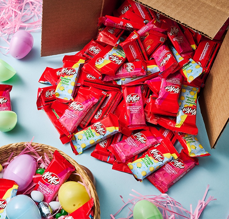 Promotional graphic showing KIT KAT Lemon and Raspberry in a bulk box