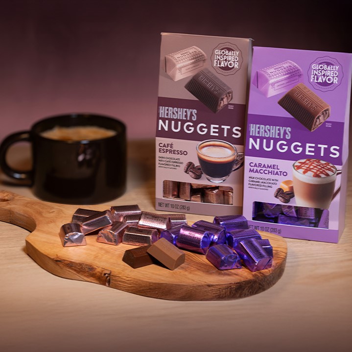 HERSHEY'S CAFÉ ESPRESSO AND CARAMEL MACCHIATO FLAVORED NUGGETS CHOCOLATE CANDY ON A WOODEN SERVING BOARD