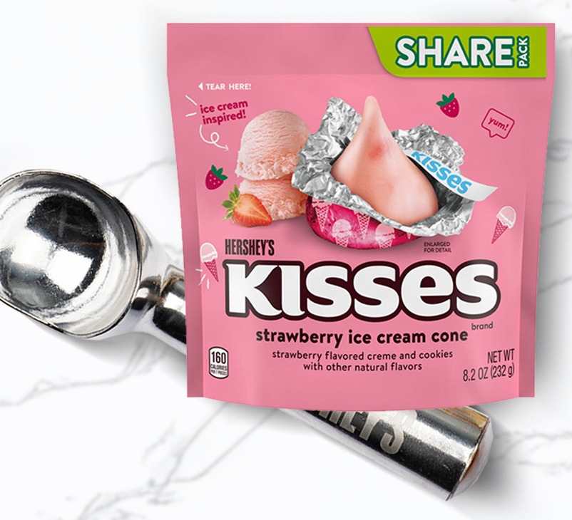 Promotional graphic featuring HERSHEY'S strawberry ice cream flavored kisses and an ice cream scoop 