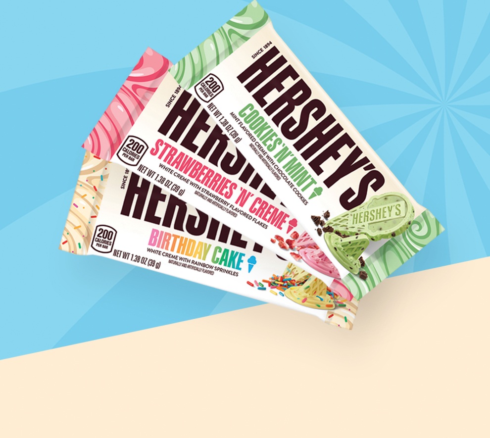 Promotional graphic featuring HERSHEY'S ice cream flavored white chocolate bars sitting on a table