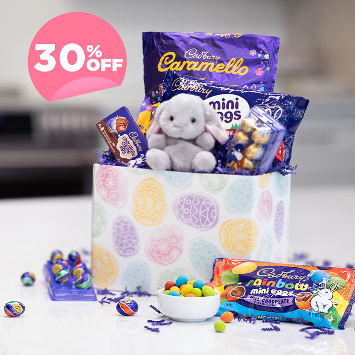 CADBURY Easter basket with assorted candies on a marble countertop
