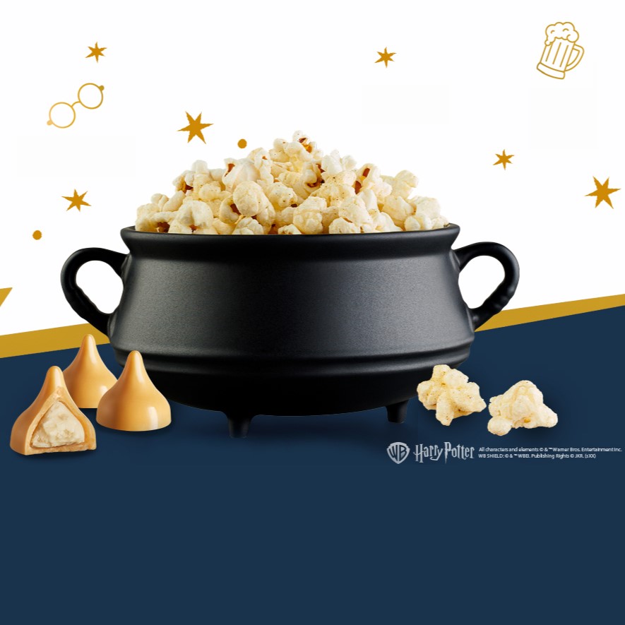 Promotional graphic SKINNYPOP Harry Potter Butterbeer Flavored Popcorn in a cauldron-shaped bowl
