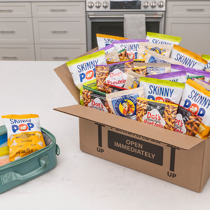 Promotional graphic featuring assorted individual serving size bags of pretzels, popcorn and puff snacks on a blue background