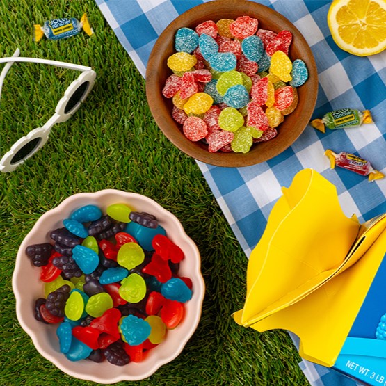 JOLLY RANCHER gummies and hard candy at a picnic setting