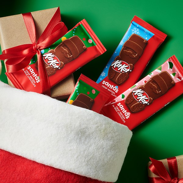 HERSHEY'S Milk Chocolate Santas spilling out of a Christmas stocking